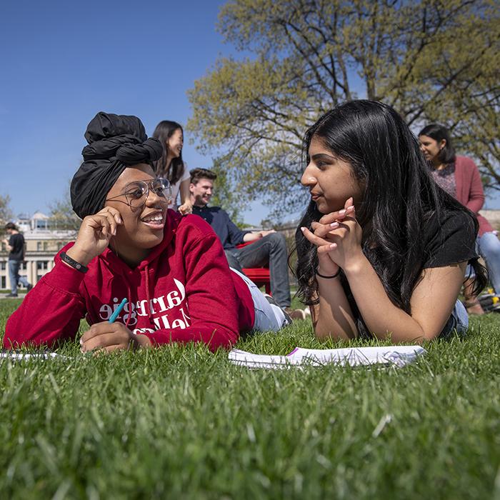 Students lay in grass